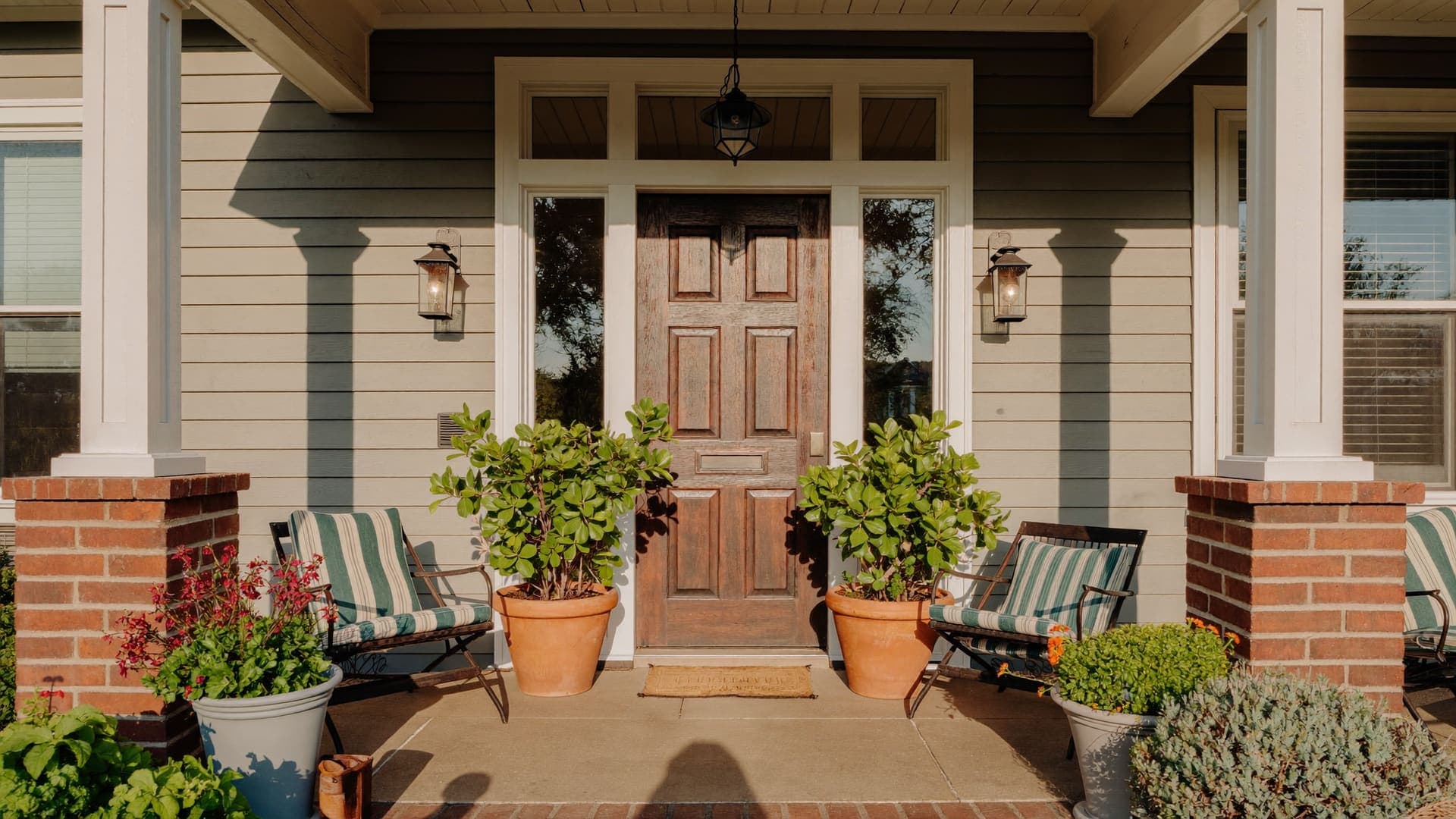 Front porch of a suburban home with painted trim and columns
