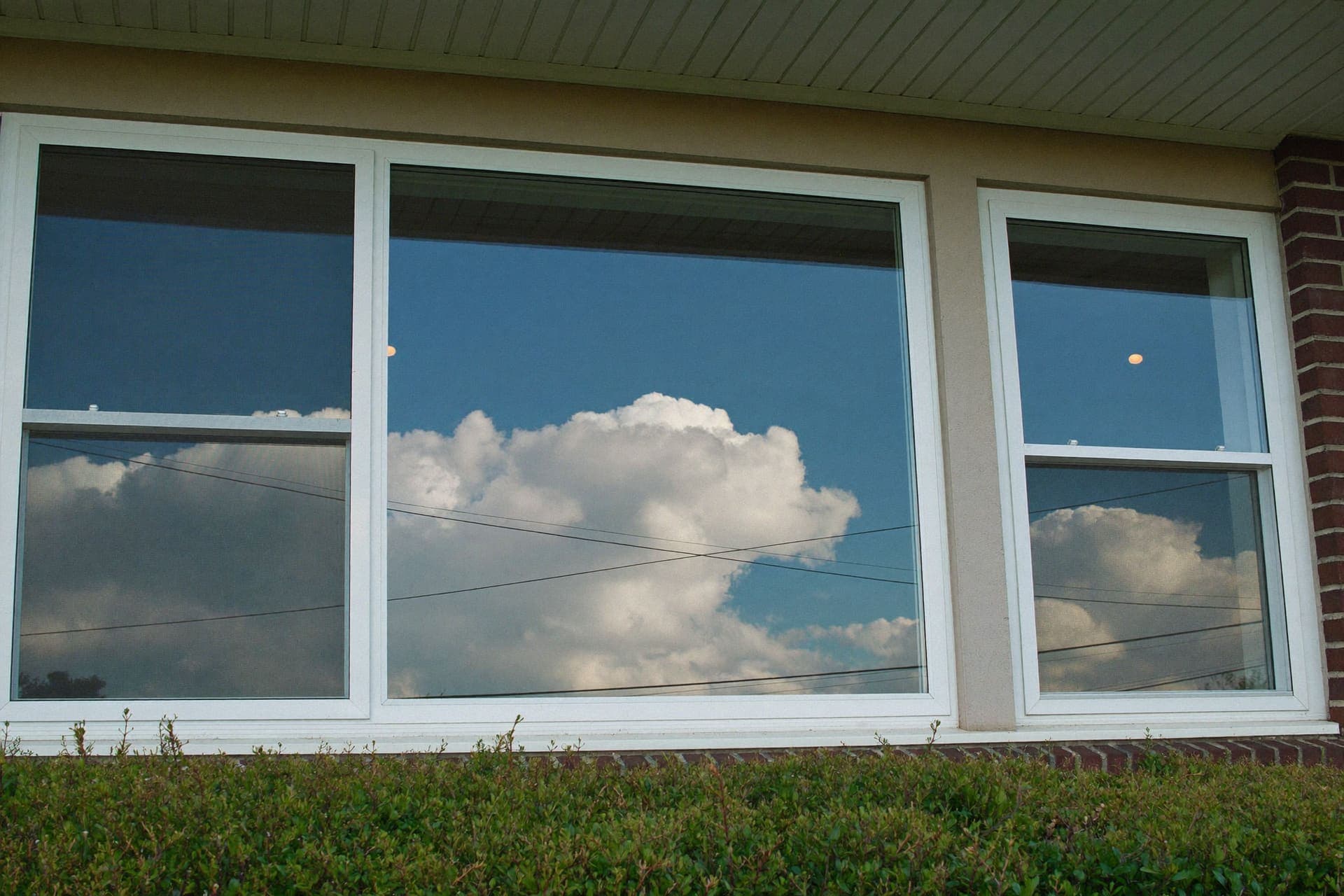 Clean residential windows on a brick home facade